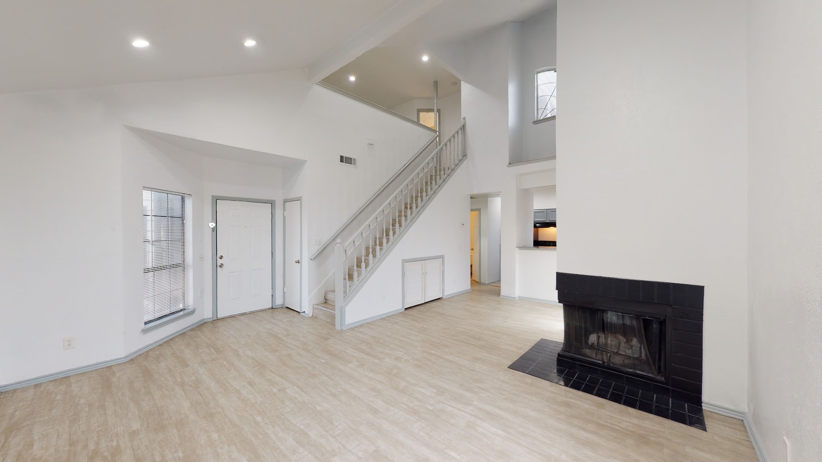 Spacious two-story townhome living room with staircase
